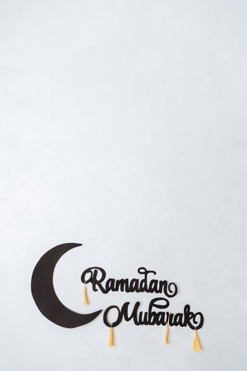Free Minimalist Ramadan Mubarak greeting card design with crescent and tassels, ideal for festive occasions. Stock Photo