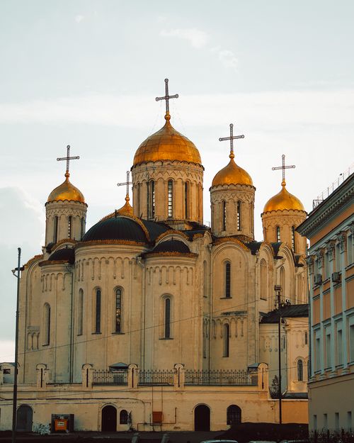 Free Capture of the Dormition Cathedral in Vladimir featuring its iconic gold domes and crosses against a bright sky. Stock Photo