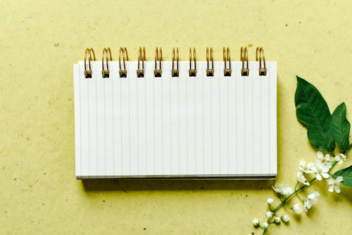 Spiral  Notebook Near White Flowers