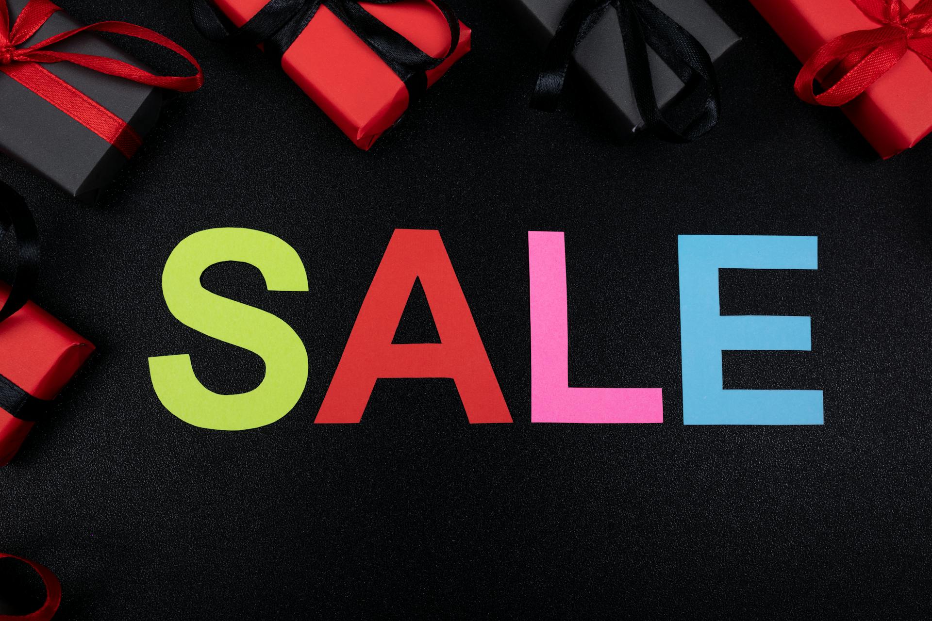 Vibrant SALE text surrounded by gift boxes offers perfect promotional imagery.