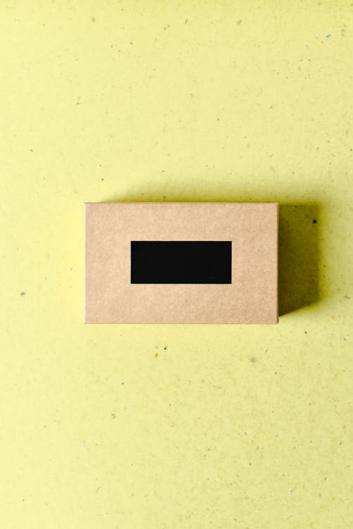 Photo of a Brown Box on a Yellow Surface