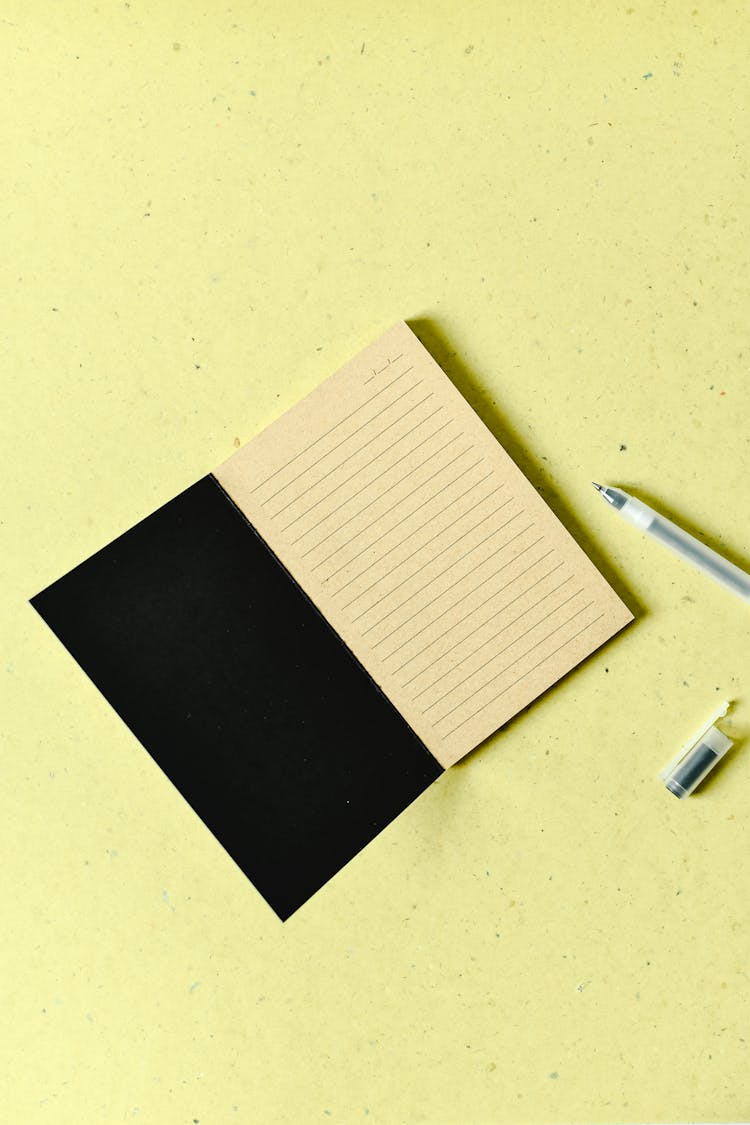 Blank Notepad Near A Ball Pen