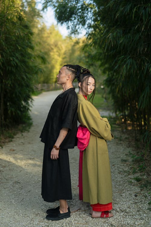 Man And Woman Standing Back To Back With Each Other