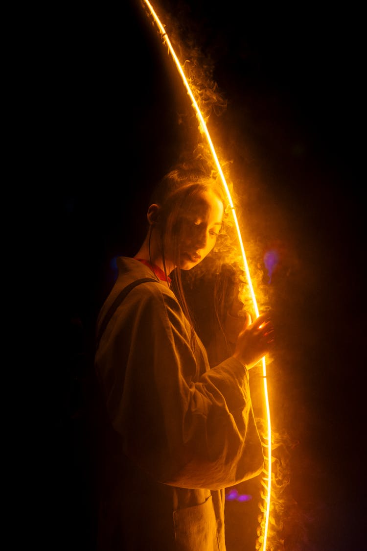 Woman Touching A Light Reflection