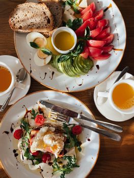 A tempting brunch spread featuring fresh vegetables, poached eggs, and avocado slices. Perfect for food lovers.