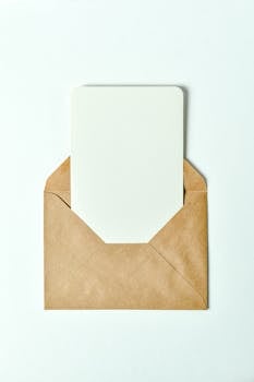 Minimalist brown envelope showcasing a blank card insert - perfect for invitations or greetings.