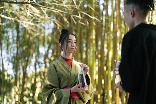 A couple dressed in traditional Japanese kimonos shares a moment in a serene bamboo forest.
