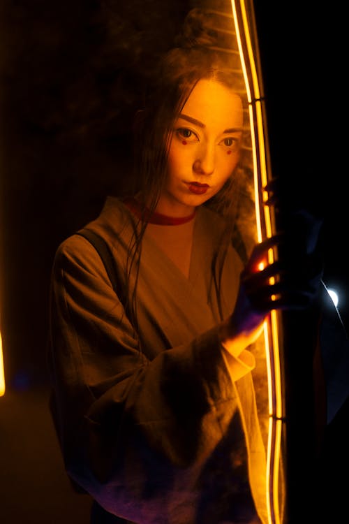 Free Woman in Green Kimono Standing Near A Ray Of Light Stock Photo