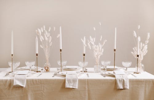 Free Setting over a Table Draped in White Table Cloth Stock Photo