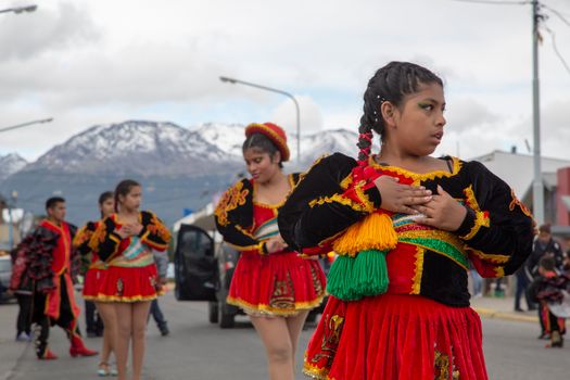 Colorful street parade featuring traditional costumes and cultural dance performance.