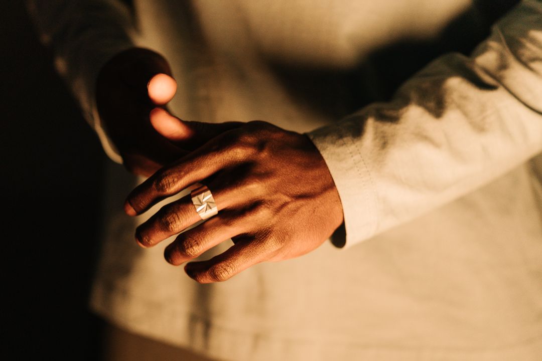 wide silver men's wedding band shown in profile on the hand — FoundryCut
