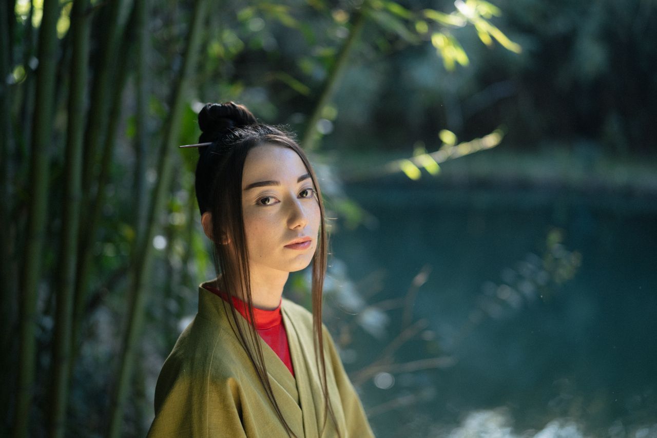 elegant portrait of a woman in a kimono surrounded by nature in a tran