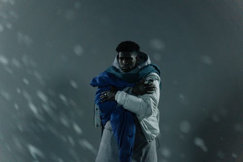 Photo of a Man with a Scarf Wearing a White Jacket