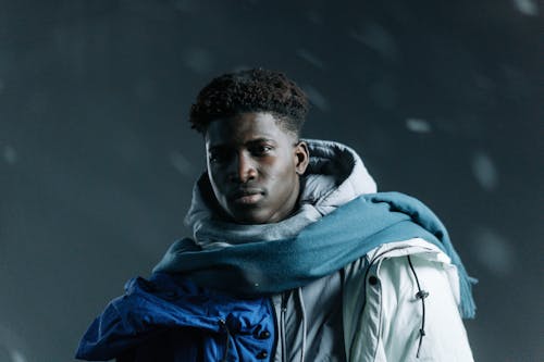 Photo of a Man Wearing a Jacket During a Blizzard