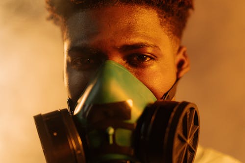 Man Wearing Respirator in Close Up Photography