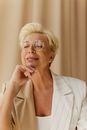 Woman in Beige Blazer Wearing Brown Framed Eyeglasses