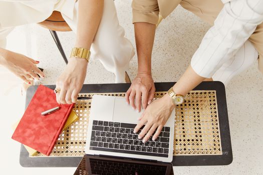 Person Wearing Gold Bracelet and White Dress Shirt Using Macbook Pro