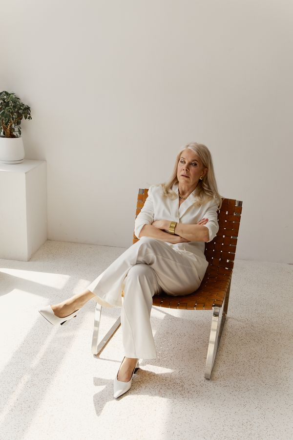 Mature woman in wide leg trousers and blouse