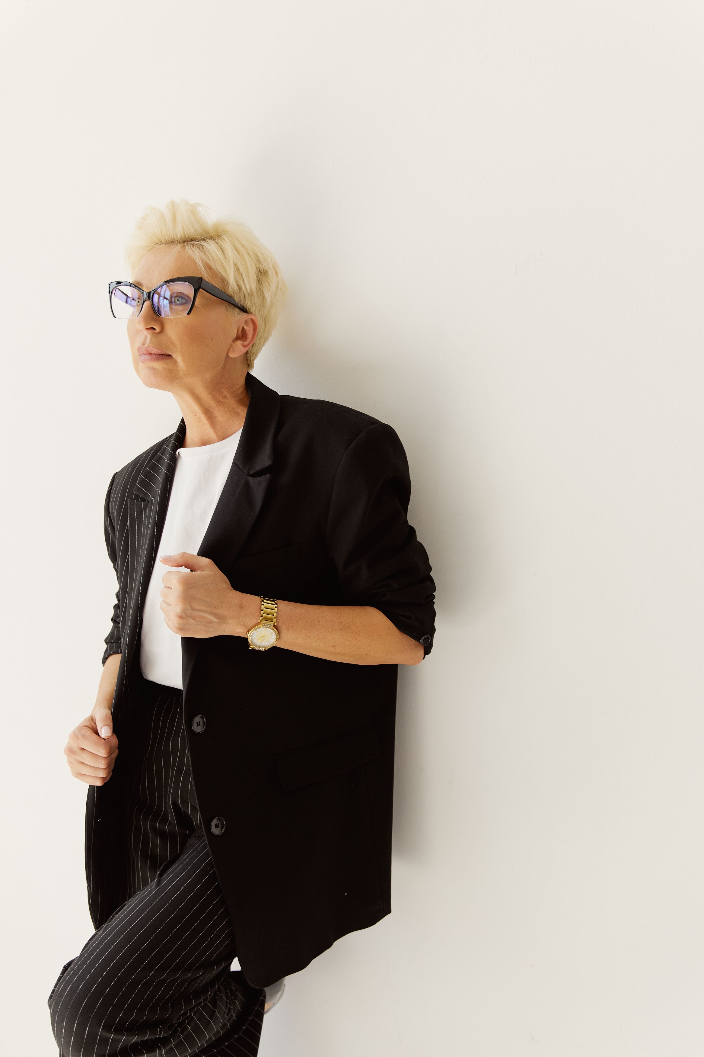 Elegant woman in a black pinstripe suit and glasses
