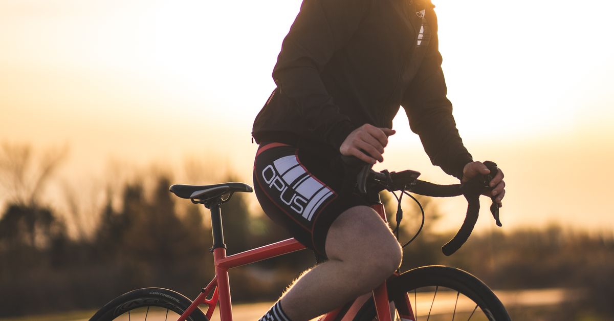 Person Riding Bike Red A Man Riding a Red and Black Bicycle · Free Stock Photo