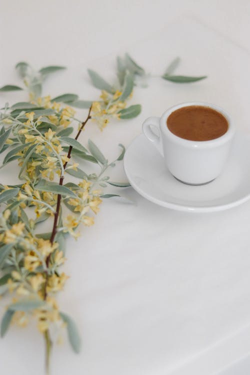 White Ceramic Cup With Brown Liquid Inside