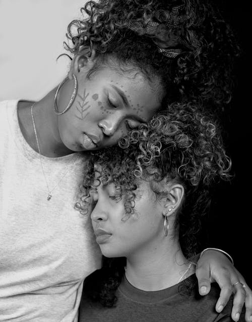 Woman Leaning her Head on Another Woman's Head