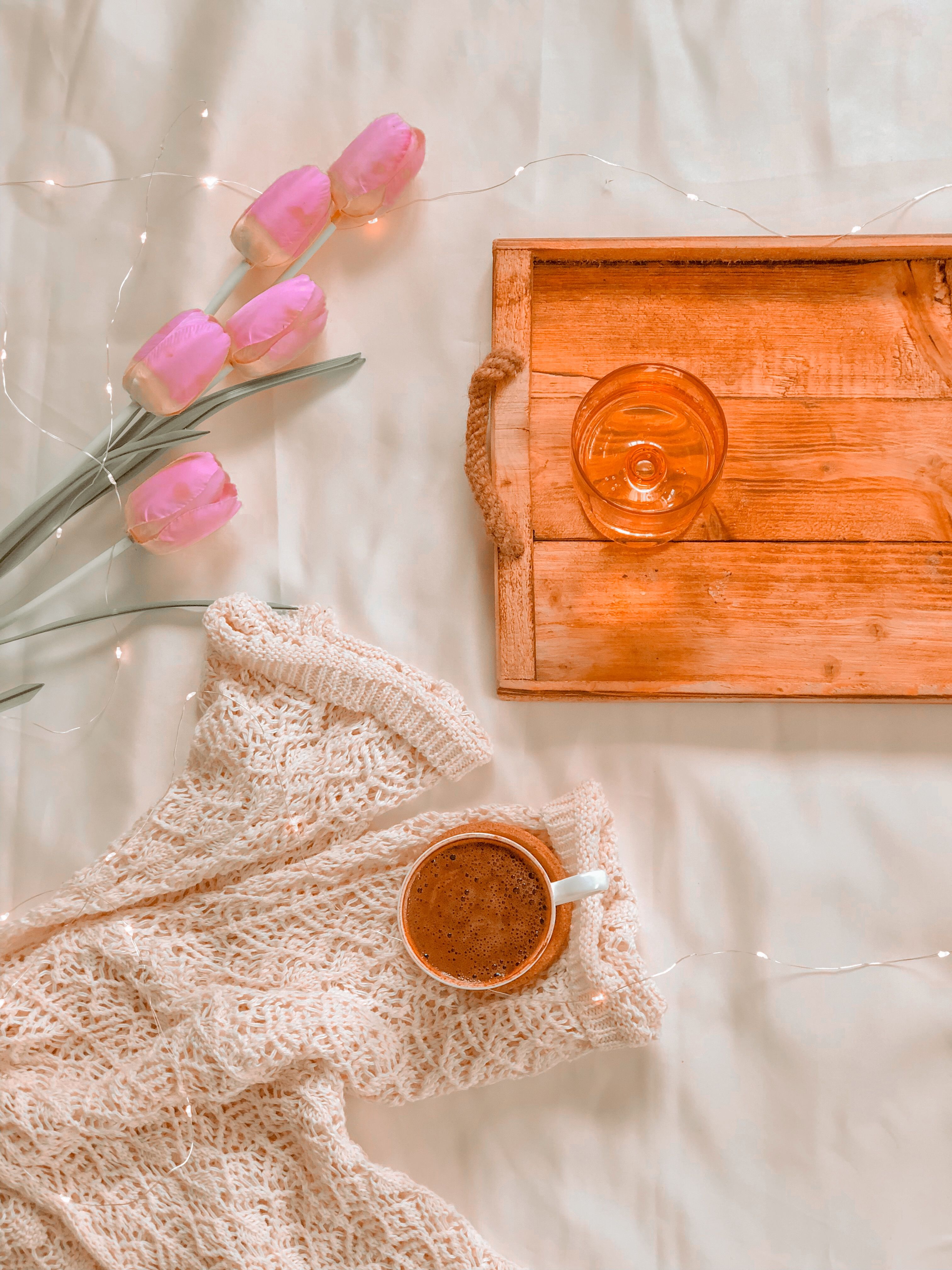 Weathered distressed wooden tray holding coffee mugs and a small plant on a boho coffee bar counter