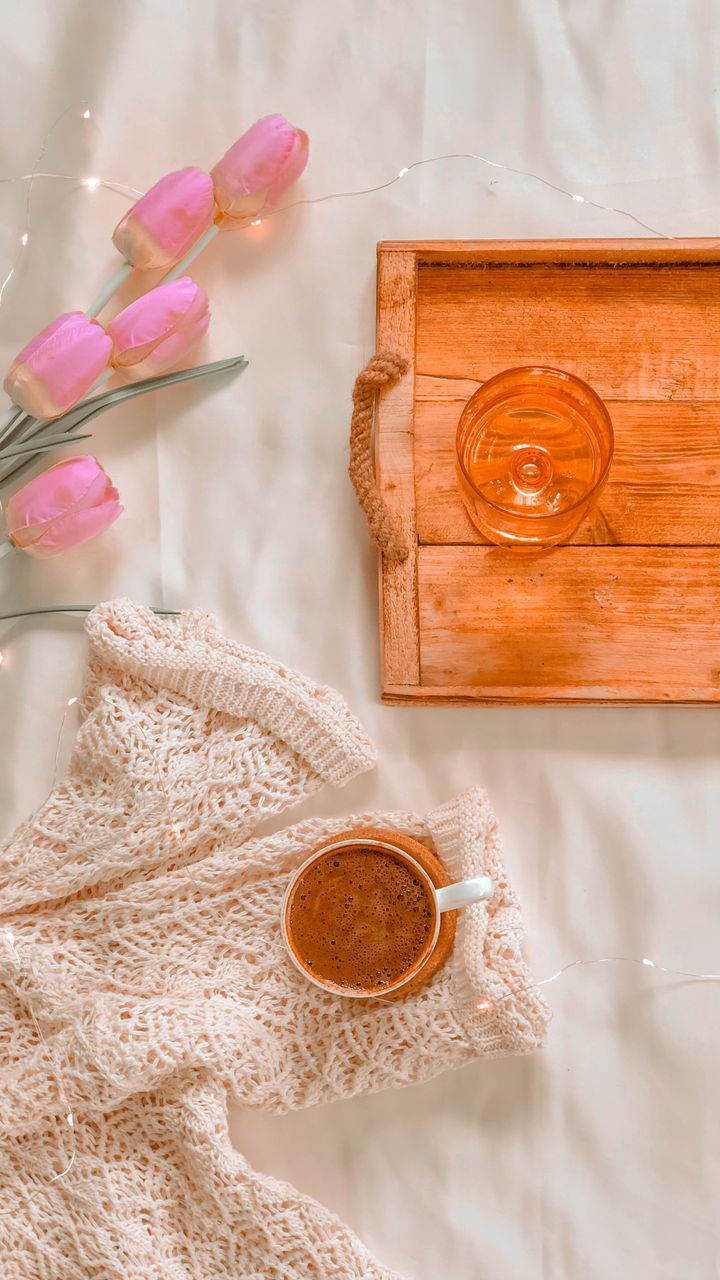 Weathered distressed wooden tray holding coffee mugs and a small plant on a boho coffee bar counter