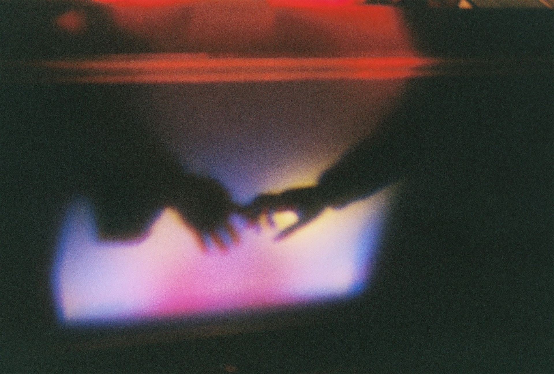 Blurred Photo of a Couple Touching Hands