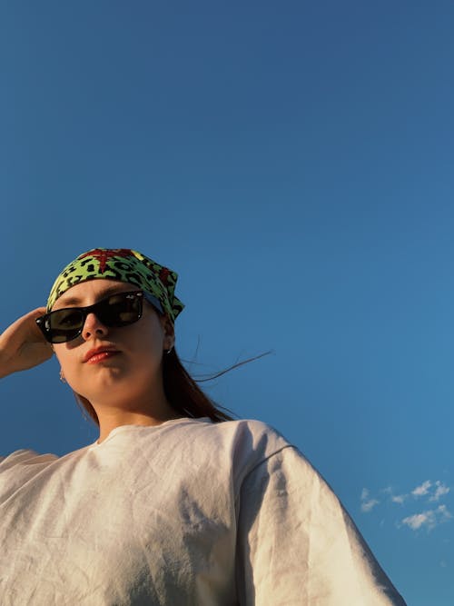 Low-Angle Shot of a Woman in Black Sunglasses Wearing a Headscarf