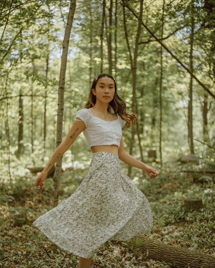 Young Asian Woman Running In Forest