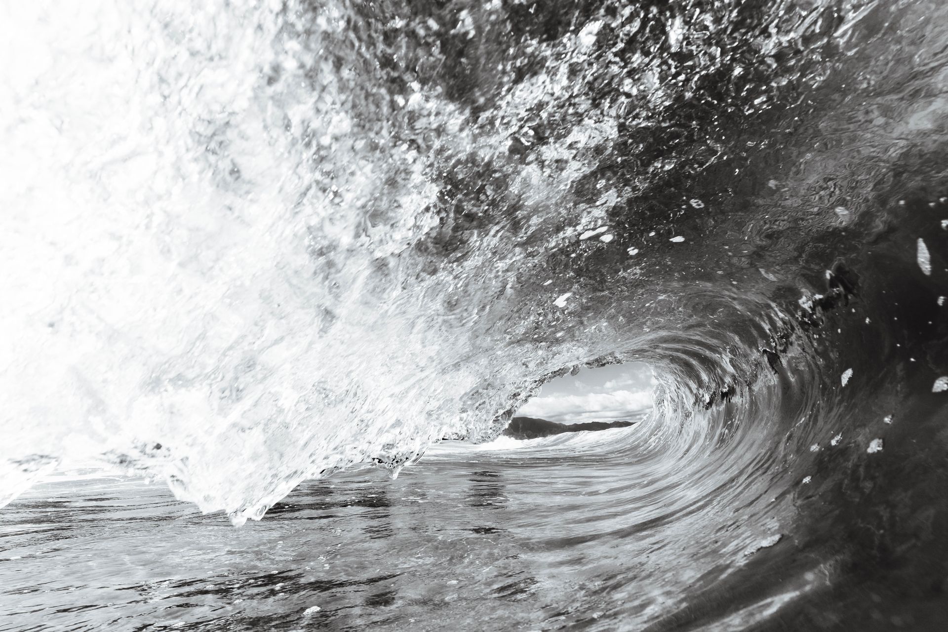 Captivating black and white photo of an ocean wave in motion, showcasing nature's power and beauty.