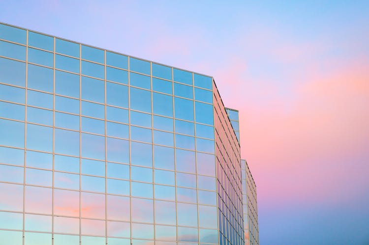 Modern Skyscraper Against Colorful Sky At Sunset