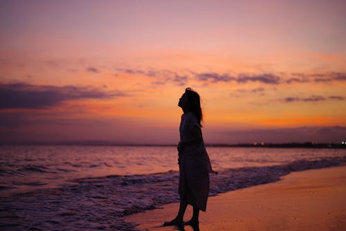 Free Silhouette of a Woman at the Beach Stock Photo