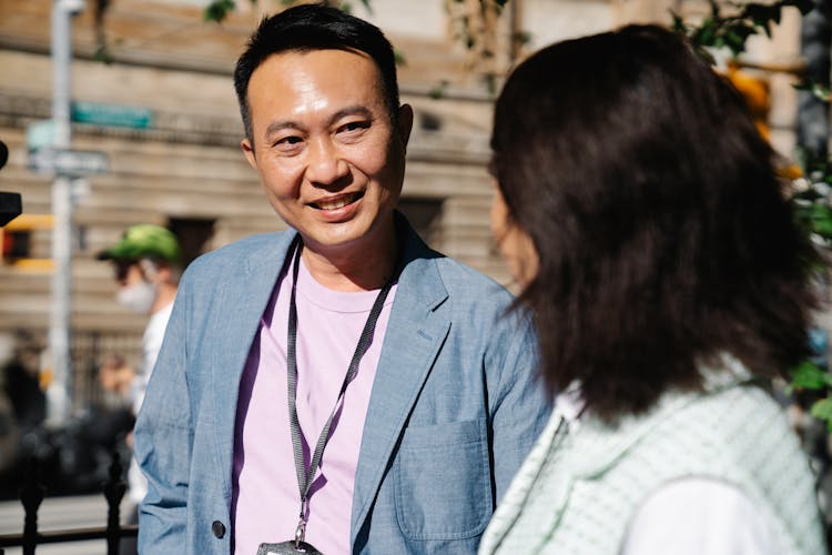 A Man In Blue Blazer Wearing A Lanyard