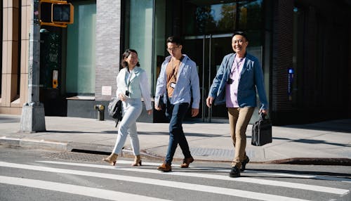 Businessmen Crossing the Street Smiling 