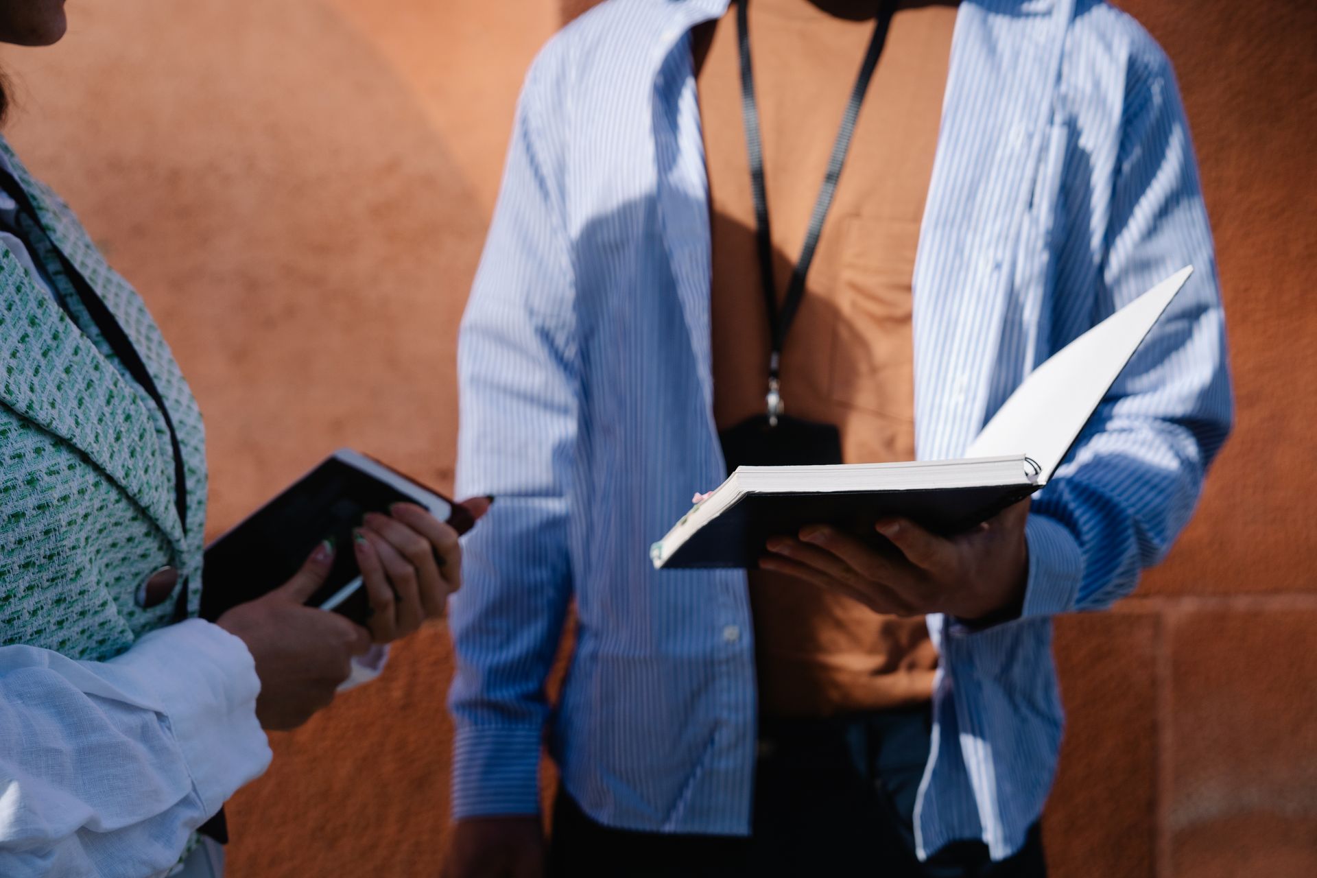 People Holding Notebooks