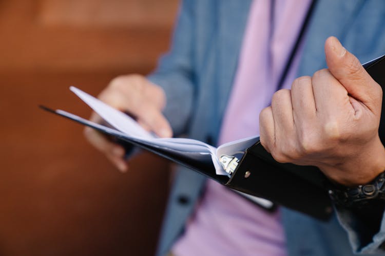 Person Holding Binder