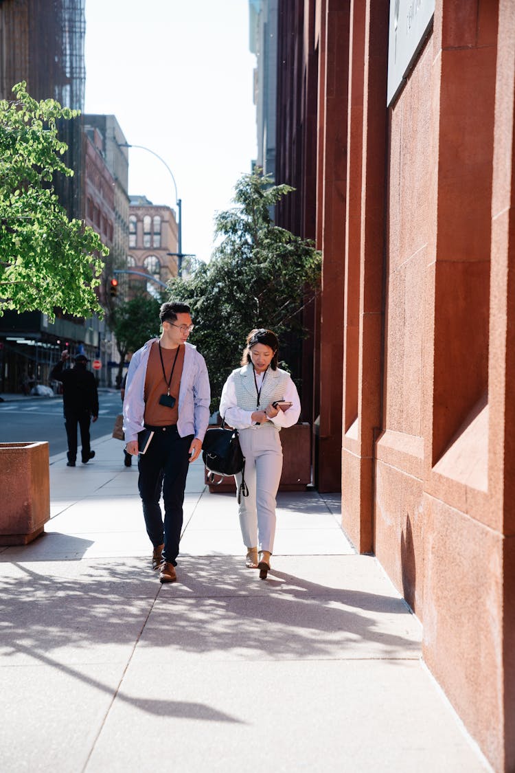 Pedestrians Walking Along Sidewalk