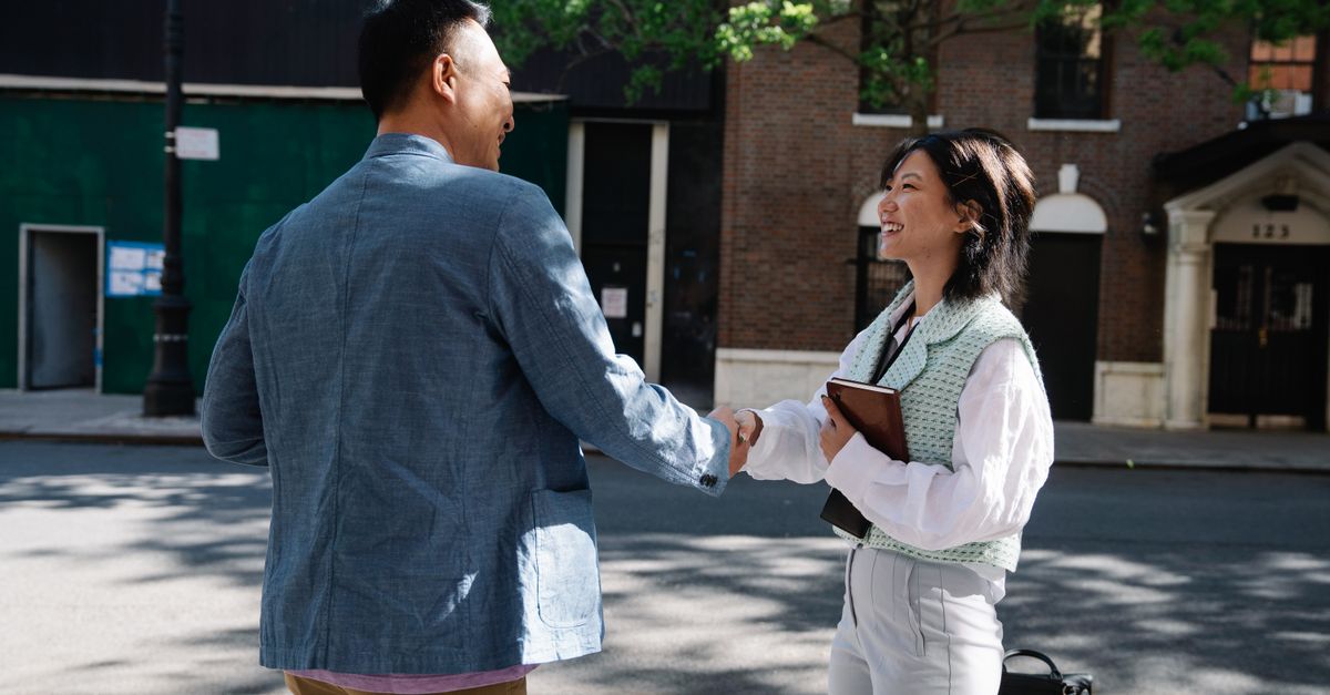 People walking into a modern church building on a sunny Sunday morning, smiling and greeting each other