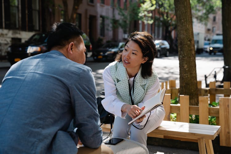 Woman Showing Calendar To Man