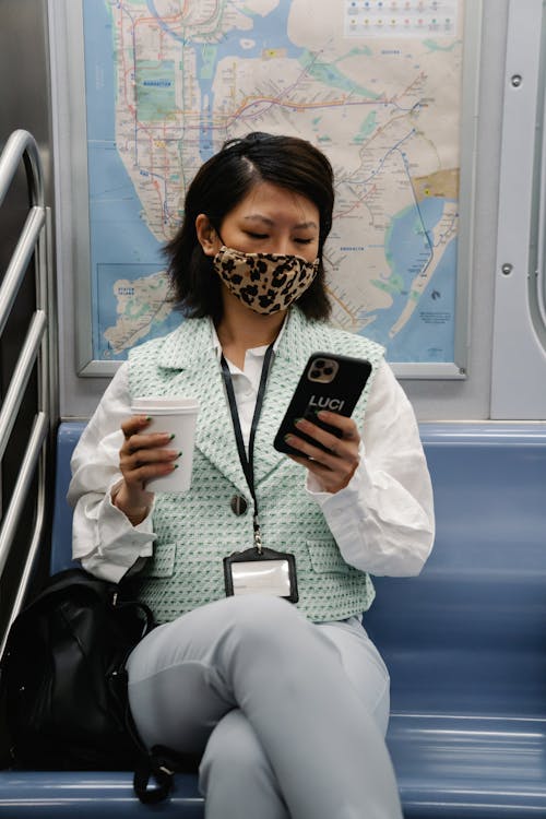 Free Woman Using Cellphone Inside a Train Stock Photo