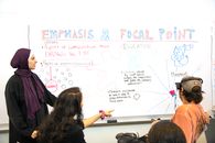 Woman in Black Shirt Writing on White Board