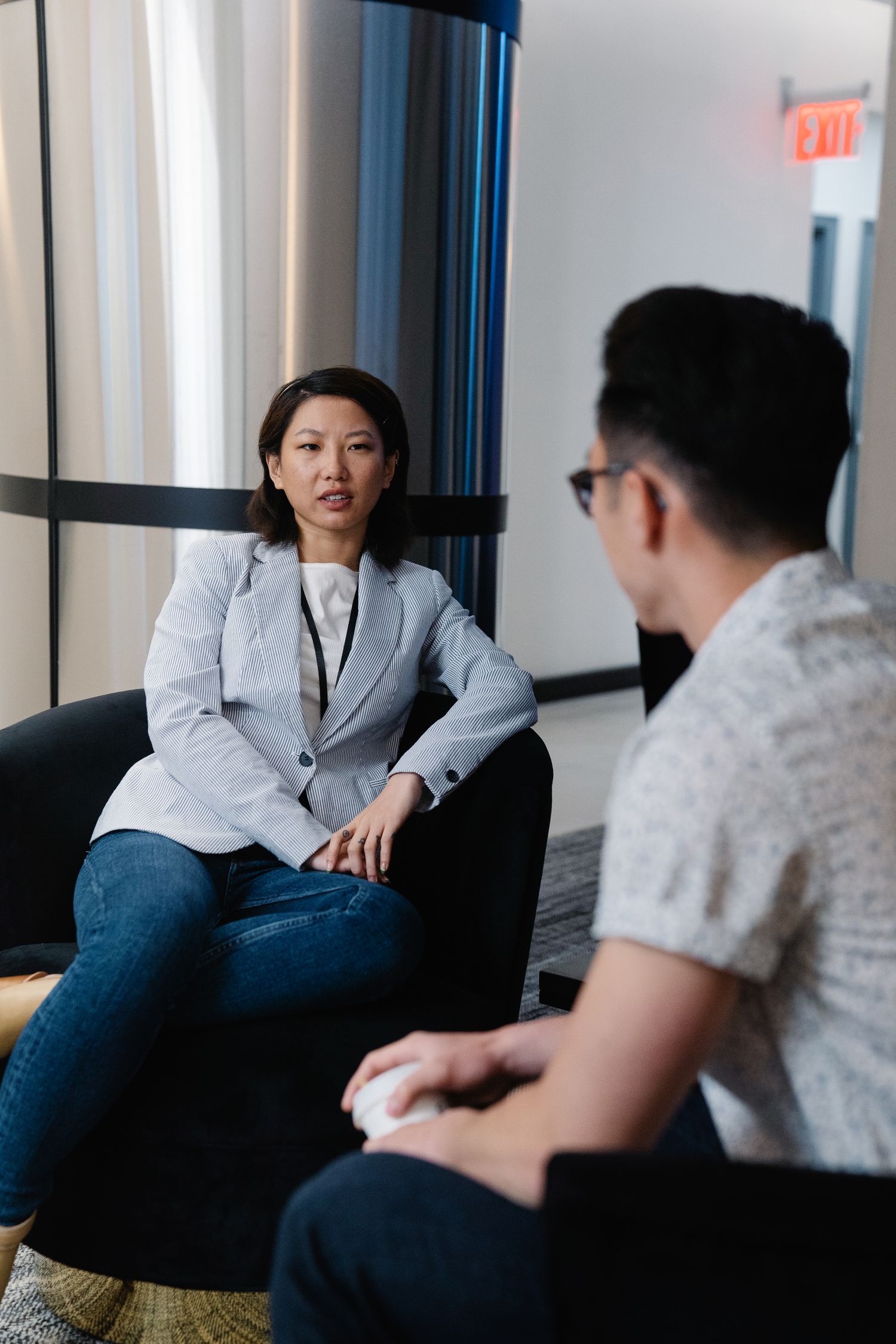 Two adult professionals having a private office conversation