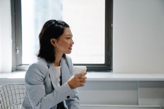 Woman in White Dress Shirt Holding White Ceramic Mug