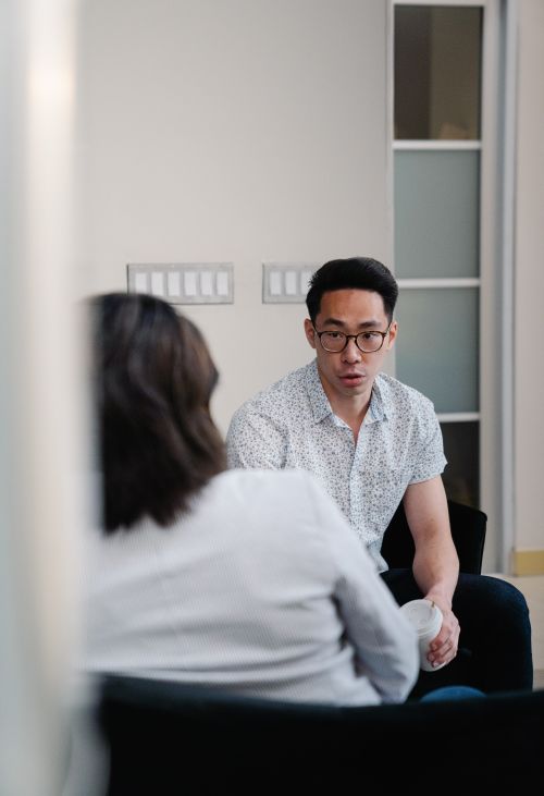 Free Two colleagues discuss work matters in a modern office setting. Stock Photo