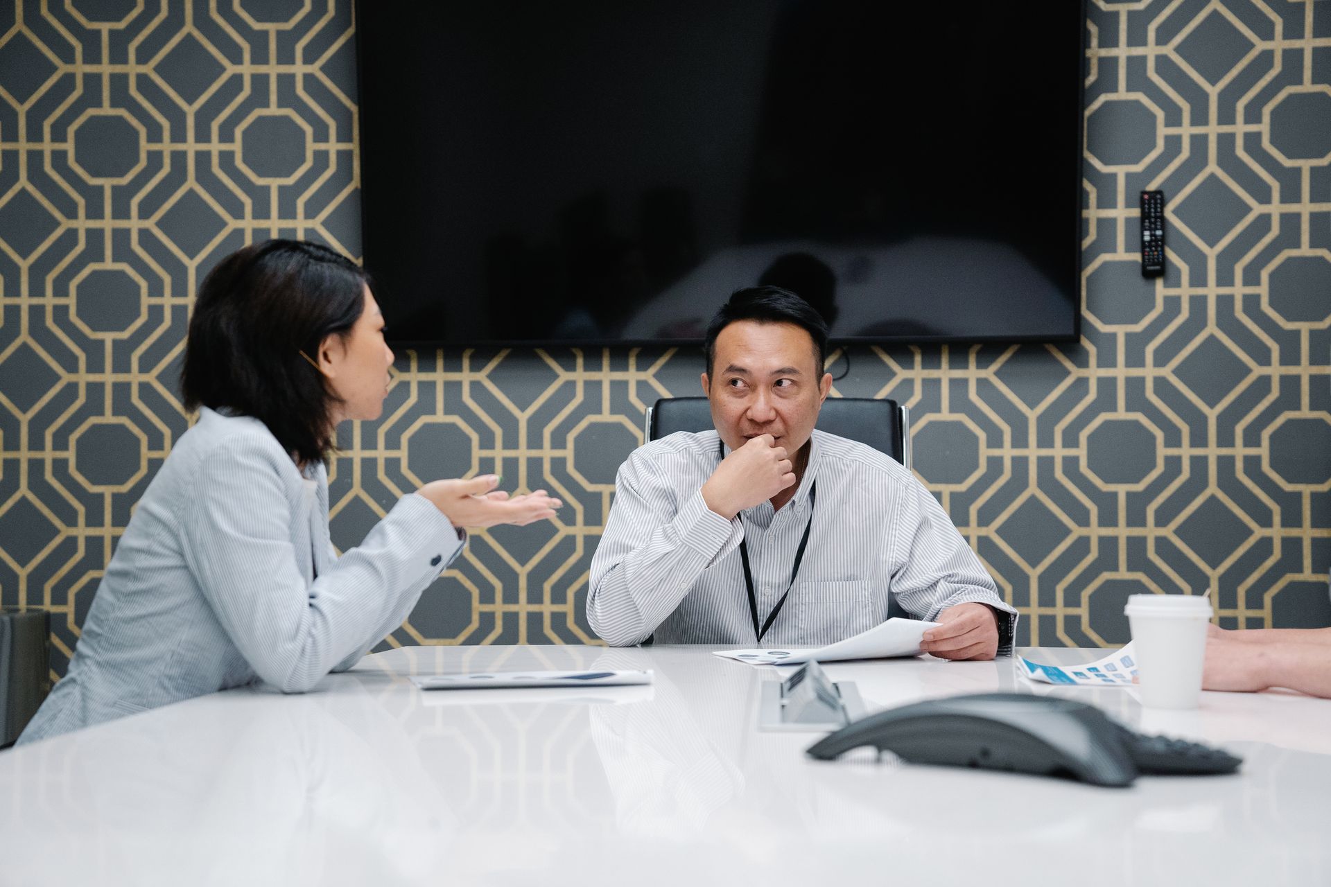 Professionals engaged in a meeting discussing ideas around a modern conference table.