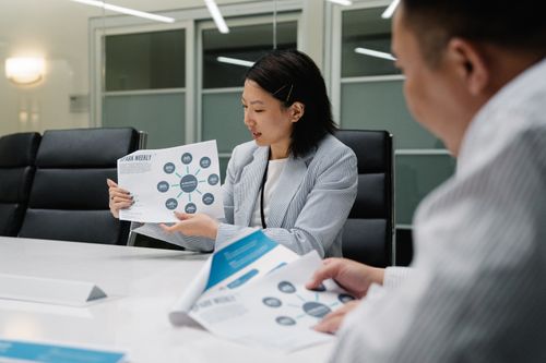 Free Colleagues in a modern conference room analyzing business reports and strategies during a meeting. Stock Photo