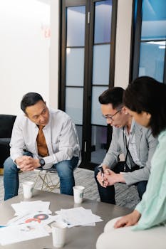Three colleagues engage in a collaborative brainstorming session in a modern office.