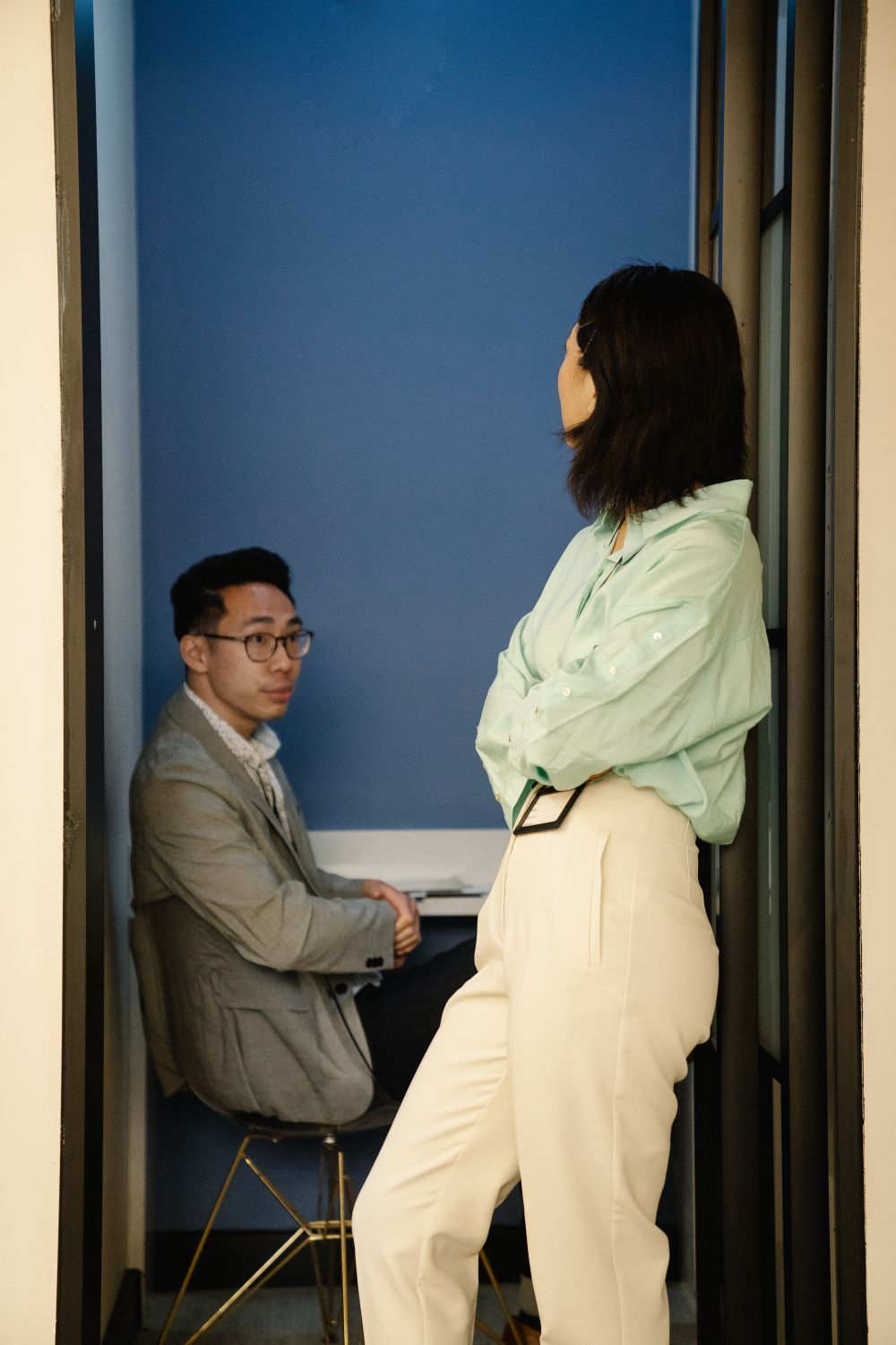 Two colleagues in conversation during an all-hands — photo by Felicity Tai on Pexels
